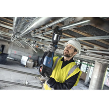 Instalatér montuje potrubí ke stropu pomocí akumulátorového lisovacího nástroje.