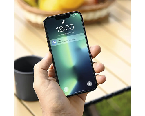 Osoba drží smartphone s upozorněním od společnosti Go Ultra.
