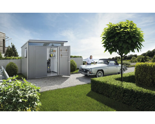 Kovová kůlna s otevřenými dveřmi, policemi a tlakovou myčkou, osoba leští auto