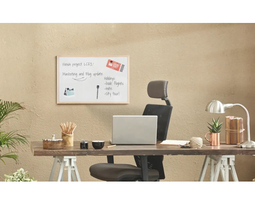 Psací stůl s tabulí, kancelářskými potřebami a notebookem pro organizaci kanceláře