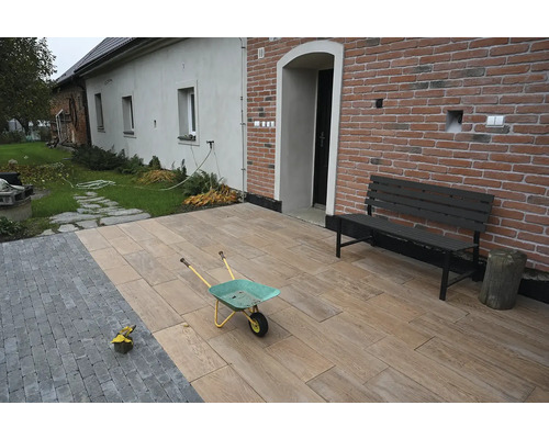 Exteriér s dřevěnou terasou, lavičkou a kolečkem