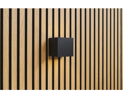 Nástěnné svítidlo ve tvaru krychle na dřevěné obkladové stěně