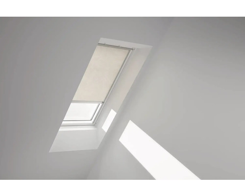 Střešní okno se žaluzií ve světlé místnosti.