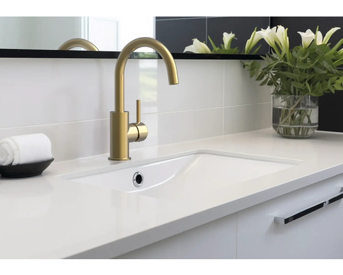 Koupelnová umyvadlová skříňka se zlatou baterií, bílým umyvadlem a ozdobnou vázou na květiny