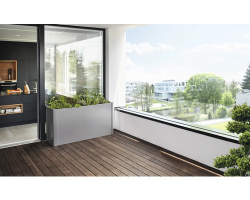 Scéna s osázeným obdélníkovým truhlíkem na balkoně s dřevěnou podlahou.