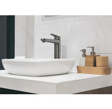 Fotografie koupelny s umyvadlem na desku, baterií a koupelnovými doplňky