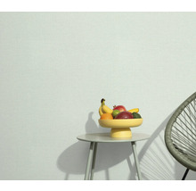 Světlá místnost se stolem, mísou s ovocem a židlí