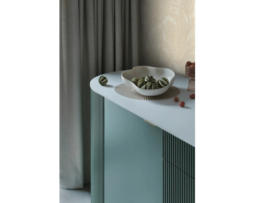 Dekorativní příborník s mísou a zeleno-pruhovanými koulemi na podložce.