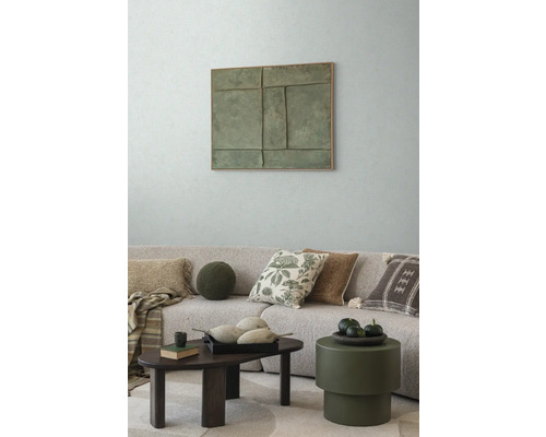 Obývací pokoj s pohovkou, polštáři, konferenčním stolkem a nástěnnou dekorací pro útulnou atmosféru