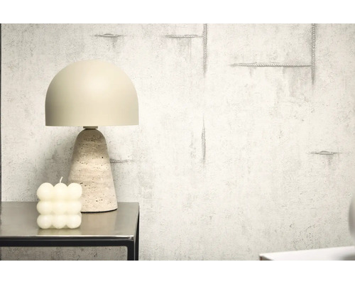 Dekorativní stolní lampa s travertinovou základnou vedle bublinkové svíčky na stole