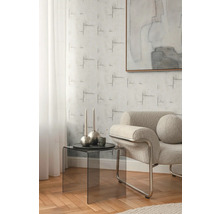 Obývací pokoj s křeslem, odkládacím stolkem a vzorovanou tapetou