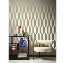 Pohled na pokoj s tapetou se vzorem, regálem a křeslem