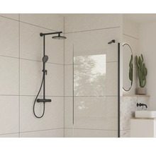 Sprchová armatura s hlavovou a ruční sprchou a sprchová stěna v moderní koupelně.