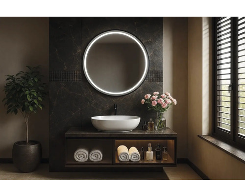 Koupelna s kulatým zrcadlem s osvětlením, umyvadlem a rostlinou