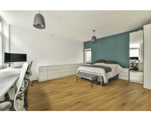 Světlá ložnice s dvoulůžkem, pracovním prostorem a dřevěnou podlahou