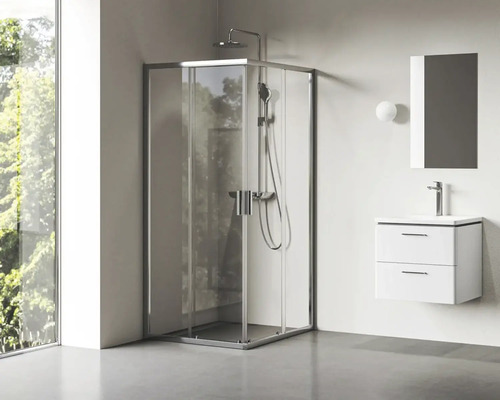 Rohová sprcha se sprchovou baterií a umyvadlo se zrcadlem v koupelně