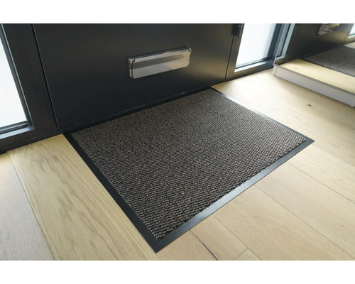 Rohožka před vchodovými dveřmi na dřevěné podlaze