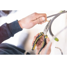 Ruce používají úzké kleště Stanley Fatmax ke svlékání kabelu.