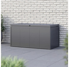 Šedý kovový úložný box před cihlovou zdí