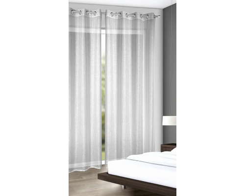 Záclony s oky z průhledné látky v ložnici.