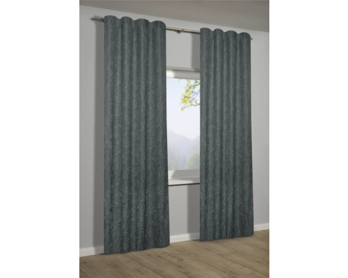 Dva šedé závěsy s rostlinným vzorem před oknem.