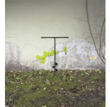 Zemní vrták v zahradě před zdí