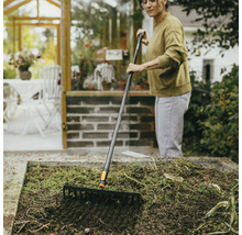 Žena hrábě zahradní záhon zahradními hráběmi