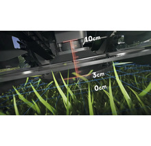 Detailní pohled na sekačku na trávu s ukazatelem výšky sečení mezi nulou a deseti centimetry
