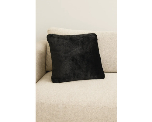 Černý dekorační polštář na pohovce