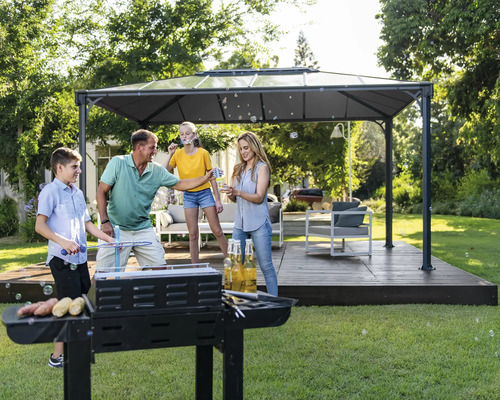 Rodina griluje na zahradě pod altánem a dělá bubliny