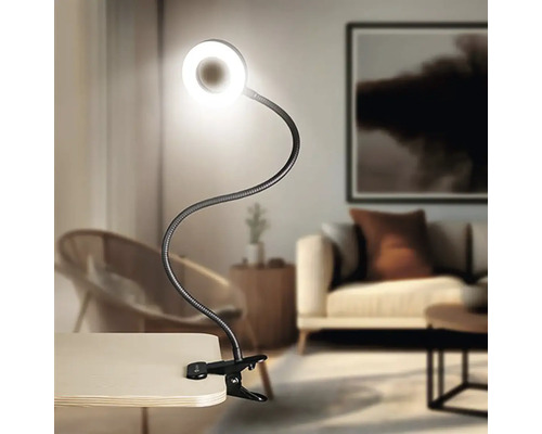 Svítidlo s klipem, flexibilním ramenem a kruhovým LED světlem na stole