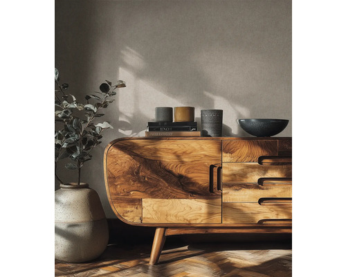 Dřevěná komoda se zásuvkami, na níž jsou knihy, mísy a rostlina ve váze