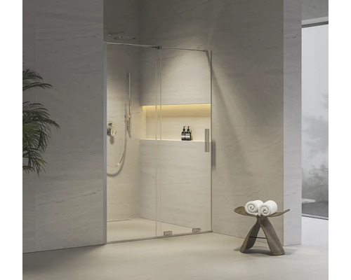 Moderní sprchový kout se skleněnými dveřmi a dešťovou sprchou ve světlé koupelně.