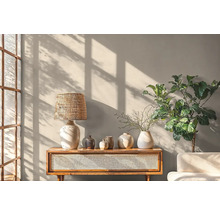 Obývací pokoj s lampou, vázami, rostlinou a dřevěnou komodou