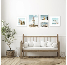 Obývací pokoj s dřevěnou lavicí, rostlinou v košíku a obrazy s pobřežními motivy na stěně