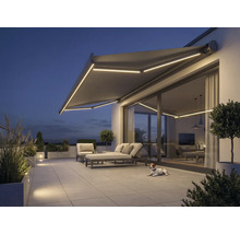 Terasa s markýzou, zahradním nábytkem a osvětlením ve večerních hodinách