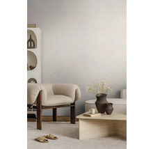 Světlý obývací pokoj se strukturovanou stěnou, moderním dřevěným křeslem, kamenným konferenčním stolkem a světlým kobercem.