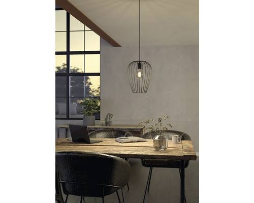 Scéna s kovovým závěsným svítidlem nad dřevěným stolem ve světlé místnosti