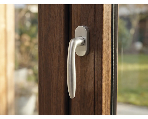 Detail hnědého okna se stříbrnou klikou