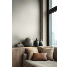 Obývací pokoj s pohovkou, polštáři a dekorativními vázami na příborníku