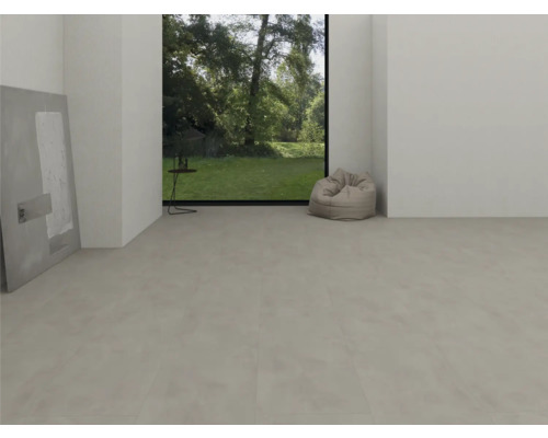 Moderní světlý pokoj se světle šedou vinylovou podlahou se vzhledem betonu, velkým oknem s výhledem do zahrady a sedacím vakem.