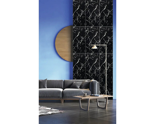 Černé nástěnné panely se vzhledem mramoru a bílým žilkováním v moderním obývacím pokoji za šedou pohovkou.