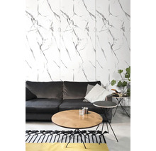 Moderní obývací pokoj s nástěnnými panely v mramorovém vzhledu, tmavě šedou pohovkou, kulatým dřevěným stolkem a černým odkládacím stolkem.