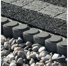 Betonová trávníková obruba s kulatou hlavou jako ohraničení záhonu vedle dlažby a štěrku.