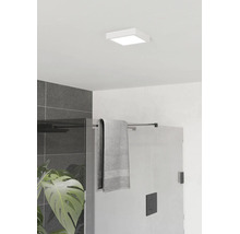 Čtvercové stropní LED svítidlo v moderní koupelně nad skleněným sprchovým koutem s černým kováním a tmavě šedými obklady.