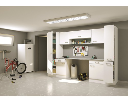 Dílna s pracovním stolem, stěnou na nářadí, vysokými skříněmi a kolem