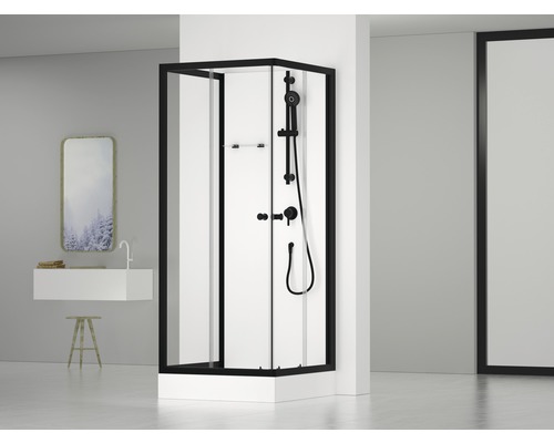 Rohová sprcha s černým rámem a sprchovou armaturou v moderní koupelně.