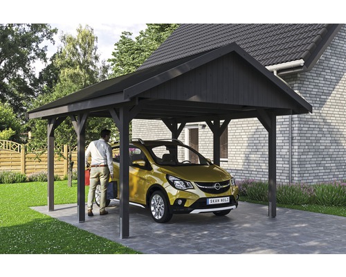 Přístřešek na auto SKAN HOLZ Wallgau 430 x 500 cm břidlicově šedý vč. šindelů Muž stojí vedle auta pod přístřeškem pro auto na pozemku