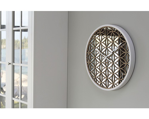 Kulaté nástěnné hodiny s květinovým vzorem na zdi