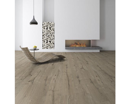 Světlý pokoj s dřevěnou podlahou, krbem a hromadou dřeva